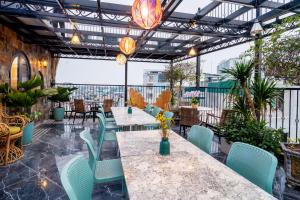a dining room with a table and chairs at Nature Hotel and Spa Ha Noi in Hanoi