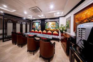 a dining room with a long table and chairs at Nature Hotel and Spa Ha Noi in Hanoi