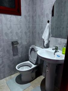 a bathroom with a toilet and a sink at Oasis Gueliz Center Marrakech in Marrakesh +11 photos