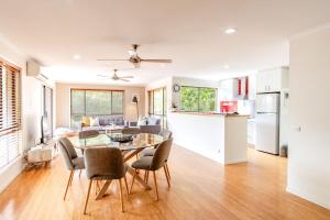 a kitchen and living room with a table and chairs at Cindy's View in Bright