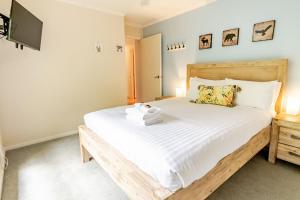 a bedroom with a large bed and a tv at Cindy's View in Bright