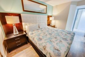 a bedroom with a bed and a mirror on the wall at Romantic Honey Moon Suite, Direct Oceanfront,Pools in Myrtle Beach
