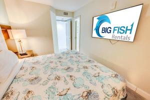 a bedroom with a bed with a big fish sign on the wall at Romantic Honey Moon Suite, Direct Oceanfront,Pools in Myrtle Beach +10 photos