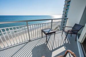 a balcony with two chairs and the ocean at Romantic Honey Moon Suite, Direct Oceanfront,Pools in Myrtle Beach