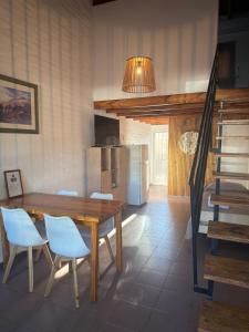 a dining room with a wooden table and chairs at Alvear centro hospedaje 2 in General Alvear