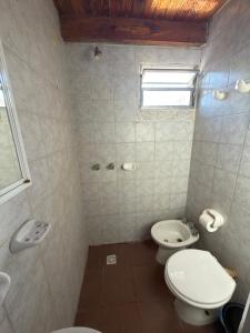 a bathroom with two toilets and a window at Alvear centro hospedaje 2 in General Alvear +12 photos