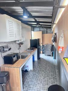 a small kitchen with a sink and a refrigerator at Sea & Sand House in Ban Khlong Khut +7 photos