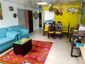 a living room with a blue couch and a table at HOUSE IBIS Salento in Salento