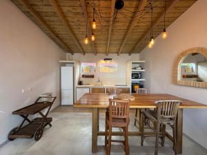 a kitchen and dining room with a wooden table and chairs at Bibi in La Trinité