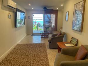 a living room with two couches and a table at Maui Beach House B & B in Kahana