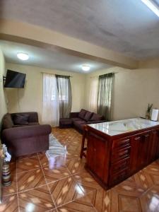a living room with a couch and a table at Valley View Inn in Roseau