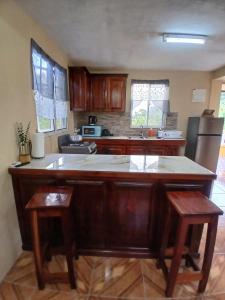 a kitchen with a large island in the middle at Valley View Inn in Roseau