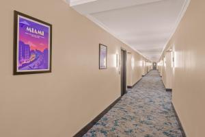 a corridor of a hallway with a painting on the wall at B&B Hotel Miami Airport in Miami
