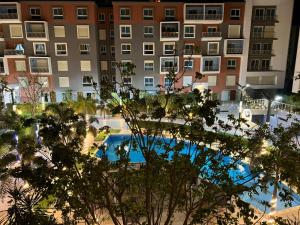 an overhead view of a building and a swimming pool at Luxury 2BR Pool View Apartment Hotel Style in New cairo