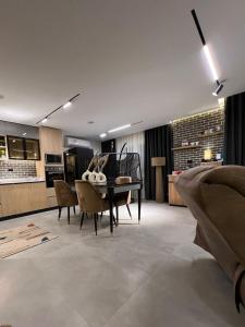 a kitchen and dining room with a table and chairs at Luxury 2BR Pool View Apartment Hotel Style in New cairo