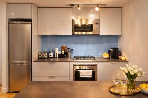 a kitchen with stainless steel appliances and a counter top at Pacific Pearl in Vancouver +4 photos