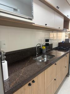 a kitchen with a sink and a stove at Tranquilidade e conforto proximo ao mar in Vila Velha