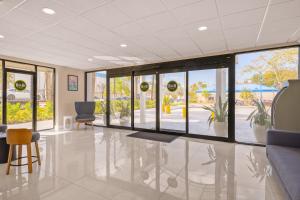 an empty lobby with chairs and windows in a building at B&B Hotel Miami Airport in Miami +16 photos