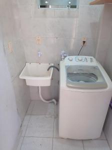 a small bathroom with a toilet and a sink at Casa Confort Praia dos Ingleses in Florianópolis