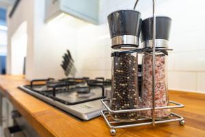 a kitchen counter with two containers of food on a stove at Upper Grosvenor Suite in Royal Tunbridge Wells