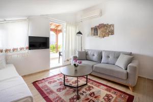 a living room with a couch and a table at Kaya Apart Datca in Datca