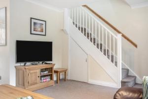 a living room with a tv and a staircase at 2 Bed in Wooler oc-l29429 in Wooler
