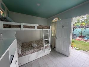 a room with two bunk beds and a door at Lucenas B&B near Maravilla White Sand Beach in Maraat +74 photos