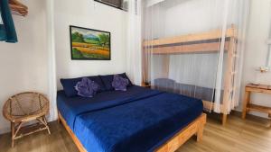 a bedroom with a blue bed in a room at Bigfin beach resort in Kota Belud +36 photos
