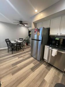 a kitchen with stainless steel appliances and a table with chairs at Riverside Retreat in Camden