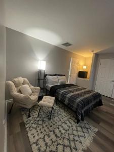 a bedroom with a bed and a chair and a rug at Riverside Retreat in Camden
