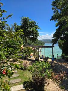 a garden with a view of the water at Bigfin beach resort in Kota Belud