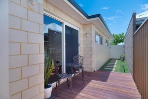 a patio with two chairs and a table on a building at Premium Large Cosy Home with Private Pool in Perth