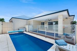 a swimming pool on a patio next to a house at Premium Large Cosy Home with Private Pool in Perth