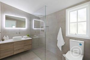 a bathroom with a toilet and a sink and a mirror at Marthas Tree Top Sanctuary in Mount Martha +14 photos