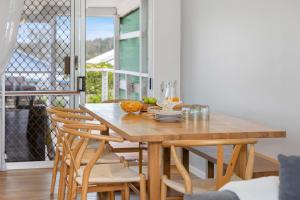 a dining room with a wooden table and chairs at Alma Beach Haven in North Haven