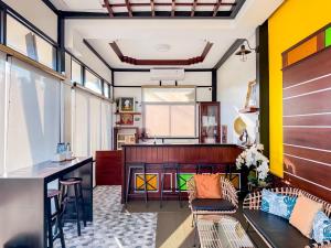 a living room with yellow walls and a table at Nangnon Hill Hug Hotel in Ban Pa Muat