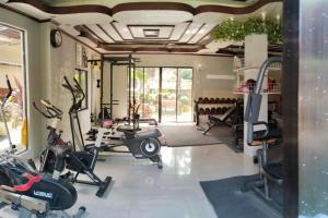 a gym with several exercise equipment in a room at Tayud Hotel by Hiverooms in Liloan