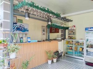 a restaurant with a counter with potted plants at Tayud Hotel by Hiverooms in Liloan