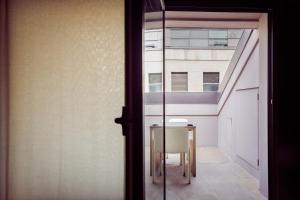 a bathroom with a mirror and a walk in shower at STRAF, Milan, a Member of Design Hotels in Milan