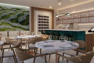 a restaurant with tables and chairs and a painting at Dolce by Wyndham Miami Beach in Miami Beach +32 photos