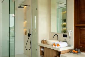 a bathroom with a glass shower and a sink at Mountain Sunshine Private Villa in Darmasaba