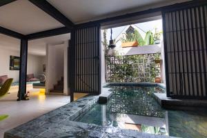 a house with a pool in the middle of a room at Casa EMMA Girardot in Girardot