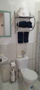 a bathroom with a toilet and a sink and a mirror at Perfect Getaway #1 in La Libertad +9 photos