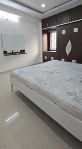 a bedroom with a large bed in a room at 3bhk Near kodapur-Hitex Exhibition&Shilparamam Art in Hyderabad