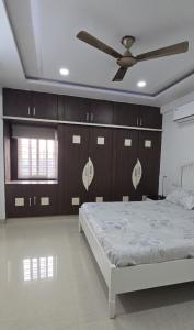 a bedroom with a bed and a ceiling fan at 3bhk Near kodapur-Hitex Exhibition&Shilparamam Art in Hyderabad