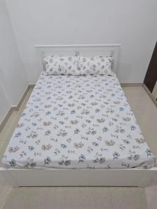 a bed with a white bedspread with animals on it at 3bhk Near kodapur-Hitex Exhibition&Shilparamam Art in Hyderabad +4 photos