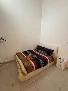 a bedroom with a bed with a teddy bear on it at Teratak Shamar in Kampong Tebok Pulai