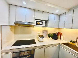 a kitchen with white cabinets and a toaster at Gray Room The White Haven In Clark in Angeles +5 photos