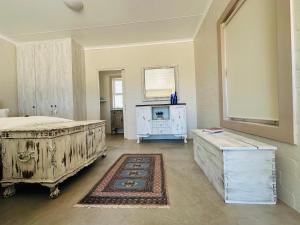 a bedroom with two beds and a tv in it at WestBed in Langebaan +224 photos