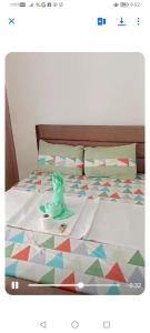a bed with a comforter with a toy on it at JY7 Rooms 414 in Cebu City +5 photos